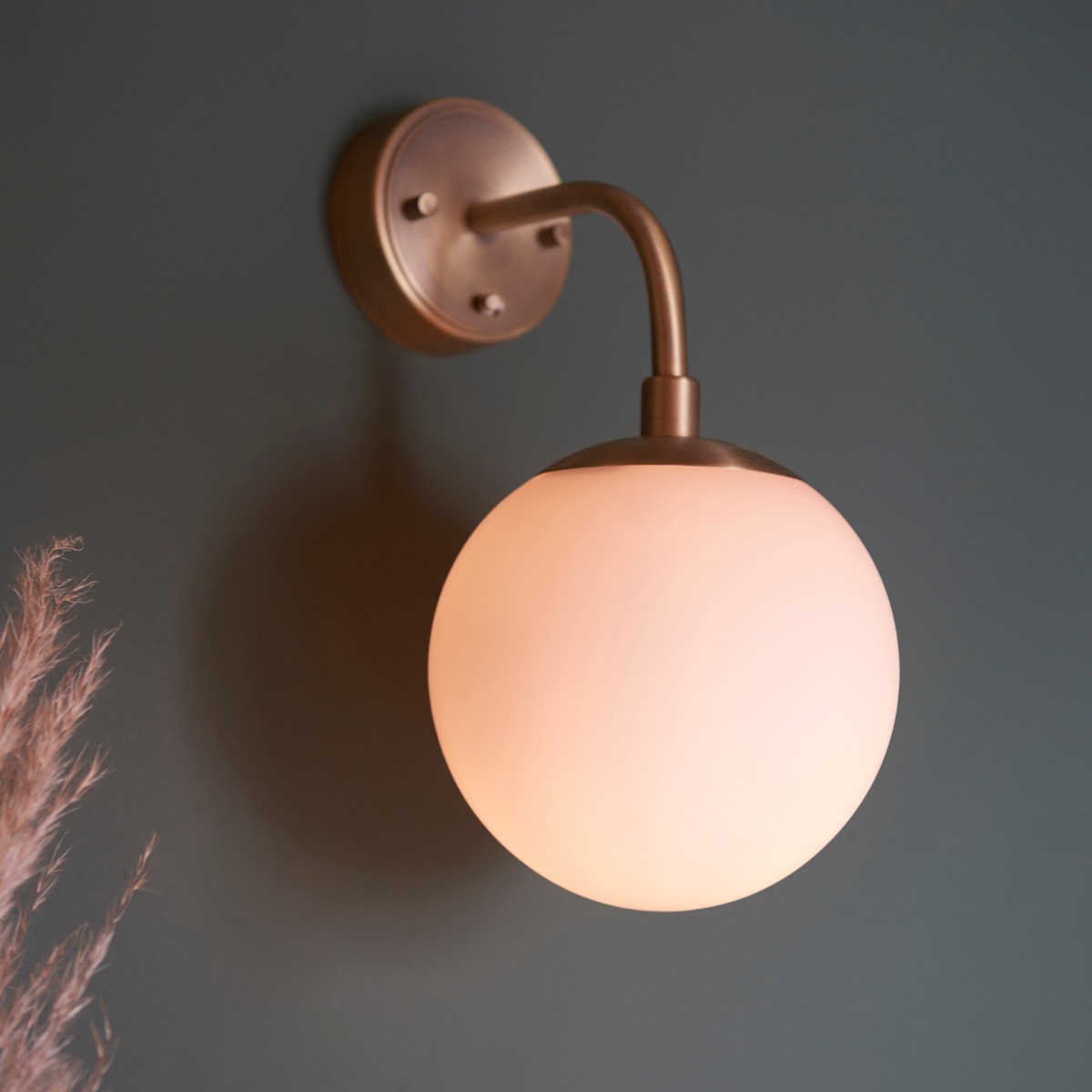 Orio 1 Light matt antique brass wall light with opal glass